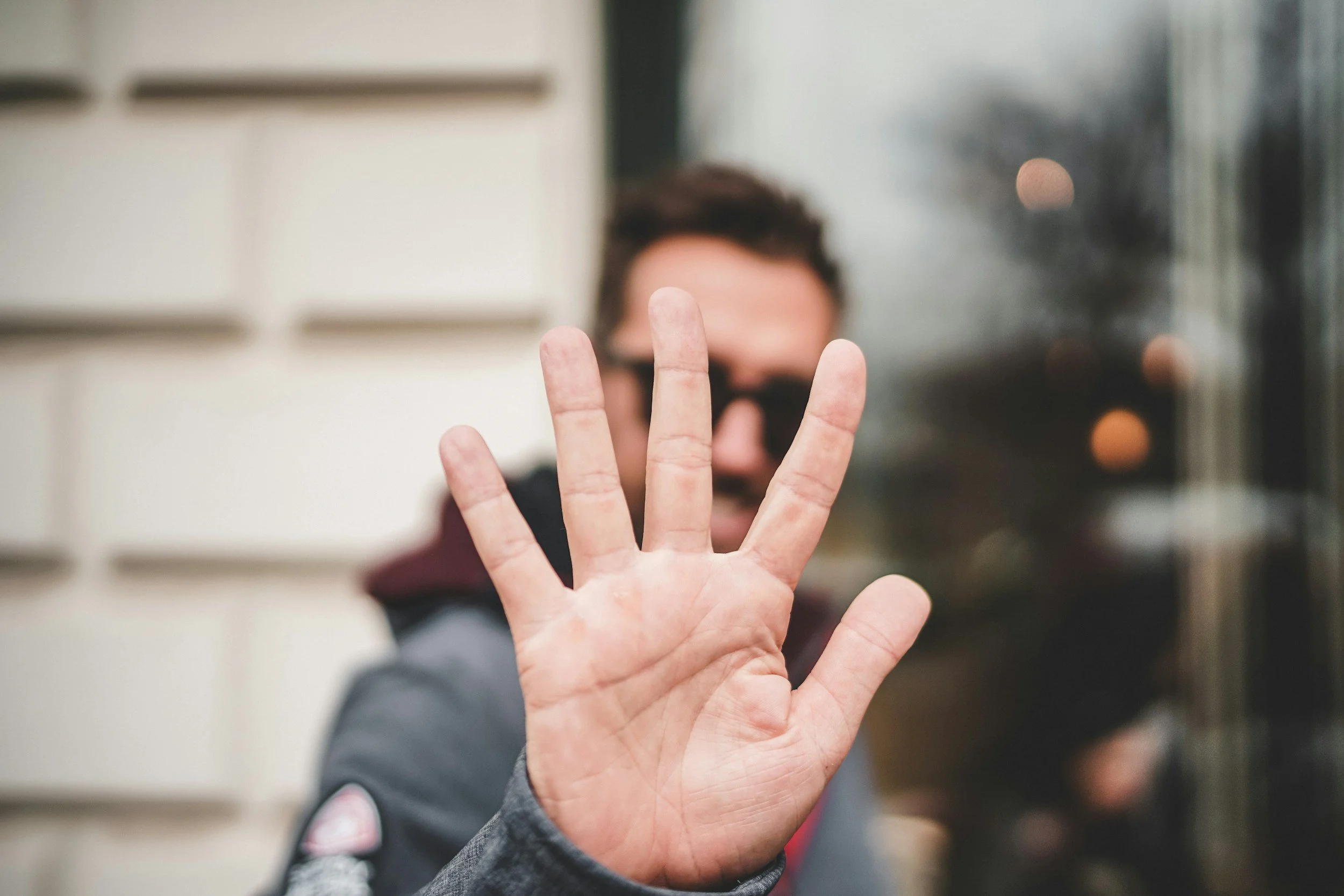 An open hand held toward the camera